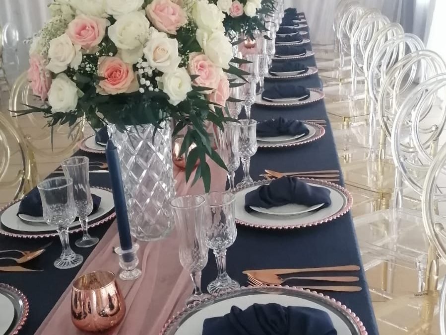 Table setting with white and blush rose centrepieces for catered events