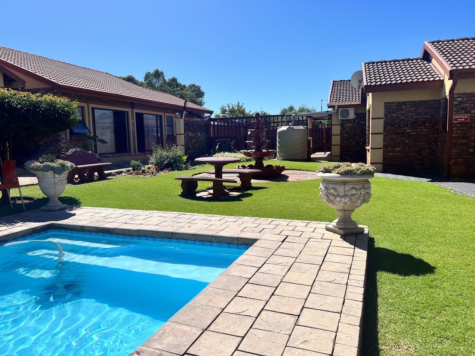 Sunlit garden and pool deck at Lotlametswe B&B