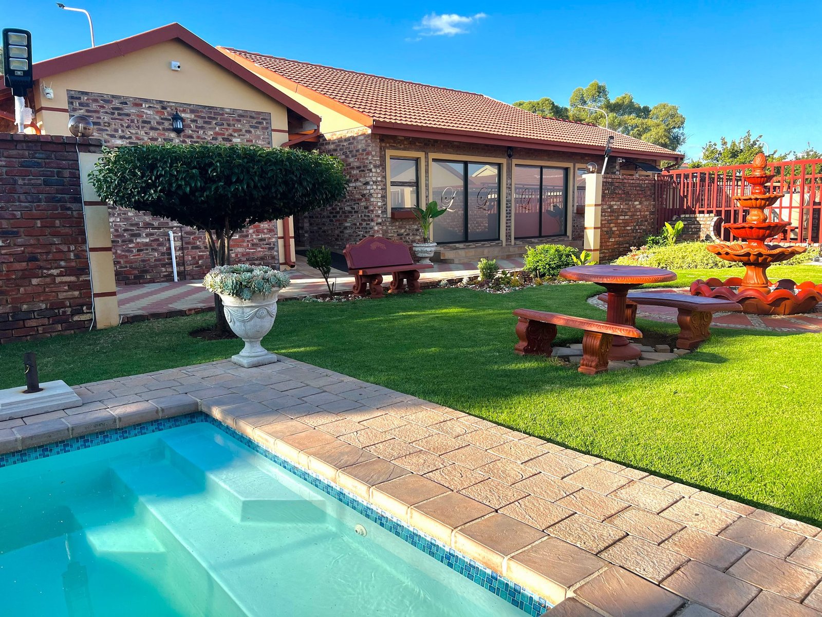 Pool, garden and patio seating at Lotlametswe B&B
