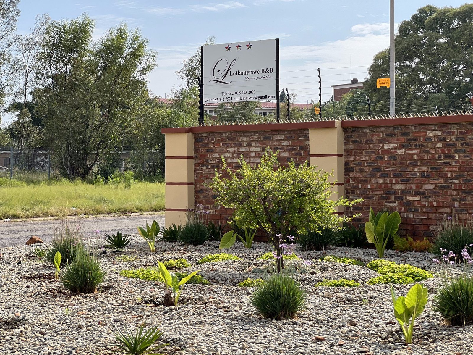 Street view of the Lotlametswe B&B boundary wall and signage